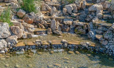 Fountain made of stones. Natural little decorative waterfall. HDR high detailed photo