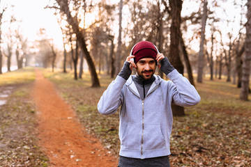 young man preparing for jogging in city park