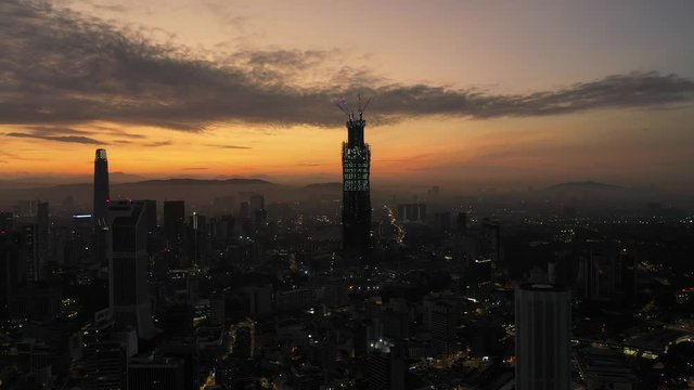 Aerial cinematic drone b-roll shot of sunrise at Kuala Lumpur city skyline. 