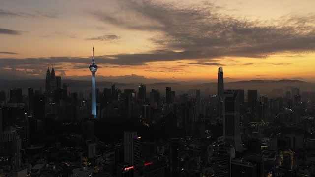 Aerial cinematic drone b-roll shot of sunrise at Kuala Lumpur city skyline. 