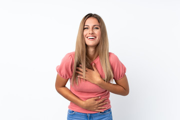 Young blonde woman over isolated white background smiling a lot