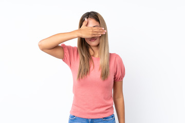 Young blonde woman over isolated white background covering eyes by hands. Do not want to see something