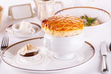 Serving of Russian borch with bun and salty with black bread