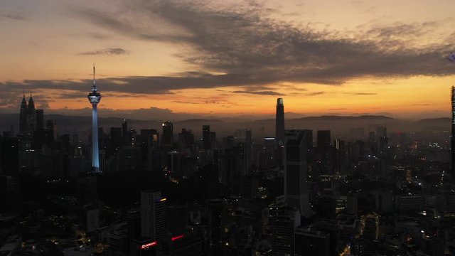 Aerial cinematic drone b-roll shot of sunrise at Kuala Lumpur city skyline. 