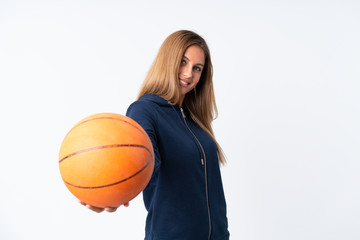 Young woman playing basketball over isolated white background