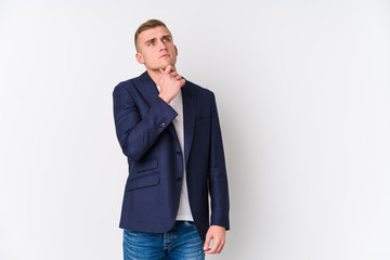 Young business caucasian man looking sideways with doubtful and skeptical expression.