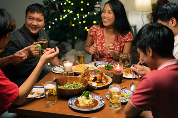 Group of Asian people have a dinner party and beer at home.