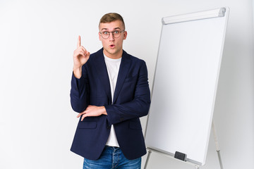 Young coaching man showing a white board having some great idea, concept of creativity.