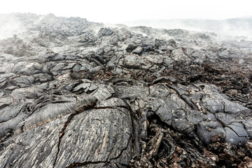 Solid lava after volcanic eruption. Lava fields close up, natural textured background.