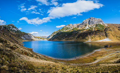 Naklejka premium Sunny autumn alpine Tappenkarsee lake and rocky mountains above, Kleinarl, Land Salzburg, Austria.