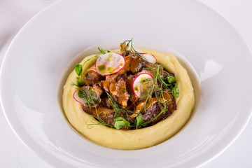 Meat with fried mushrooms and puree potatoes