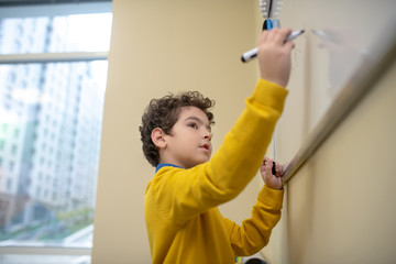 Pupil thinking what to write on the white board