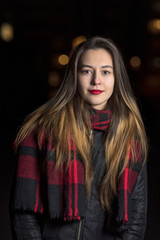 Portrait of a girl in the night city. Photographed close-up.