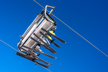 Winter sports concept. Skiers on chairlift at mountain ski resort 