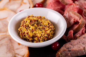 Mustard sauce of several types of mustard, served with meat