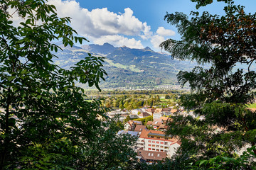 Mountains and a view from the height of the valley with houses at the bottom of a Sunny summer day