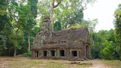 Fototapeta na wymiar Abandoned stone rock architecture at Preah Khan temple Angkor Wat complex, Siem Reap Cambodia. A popular tourist attraction nestled among rainforest.