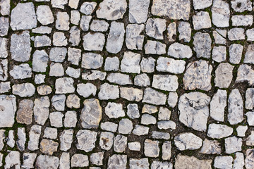 Stone pavers of gray stones near the old castle.