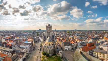 Obraz premium Aerial panorama of The Saint Nicholas Church and Gent cityscape from the Belfry of Ghent on a sunny day. Important building in Romanesque and Scheldt Gothic style