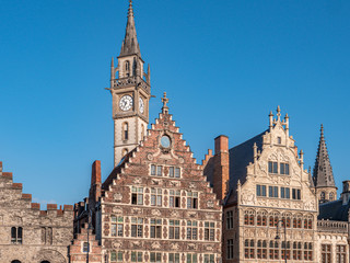 Fototapeta premium Buildings of the Graslei, quay in the promenade next to river Lys in Ghent, Belgium and St Michael's Bridge at sunset.
