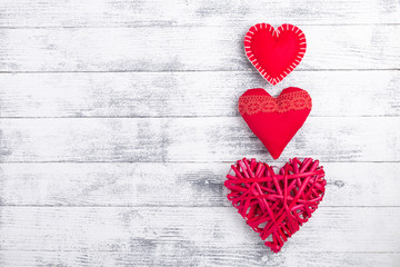 Fototapeta premium Red hearts on wooden white background. The concept of Valentine Day. Copy space for your text