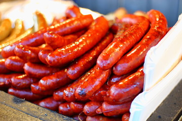 Fried, juicy, meat sausages glossy with fat.