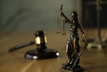 Symbol of law and justice on wooden table in lawyer office