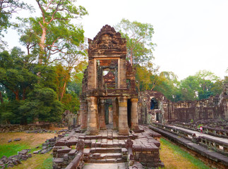 Landscape view of demolished stone architecture at Preah Khan temple Angkor Wat complex, Siem Reap Cambodia. A popular tourist attraction nestled among rainforest.