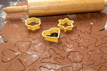 Cutting figures from the dough using special stencils for making ginger Christmas cookies. Home,...