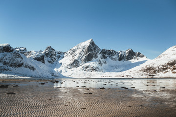 Fototapeta na wymiar Winter mountain landscape Lofoten Norway during low tide