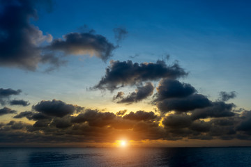 Fototapeta premium Sunset sky at the lake with dark clouds.