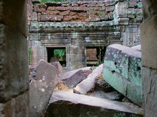 Stone rock ruins at Preah Khan temple Angkor Wat complex, Siem Reap Cambodia. A popular tourist attraction nestled among rainforest.