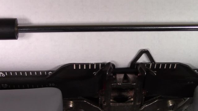 A close up video of the words "Logic 101 " being typed on white paper in an old manual typewriter. Shot in macro.