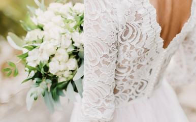 Bride holds a wedding bouquet, wedding dress, wedding details
