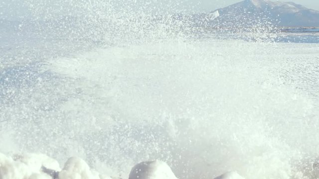 Sea wave bubbling foam snow, sea in winter.