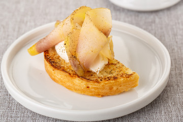 Pieces of sluggish lard with black pepper, served with toast and butter