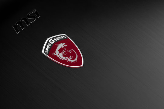Close up of MSI logo on black polished aluminum surface with red dragon  symbol. Wrocław 02 January 2020, Poland. Stock Photo | Adobe Stock
