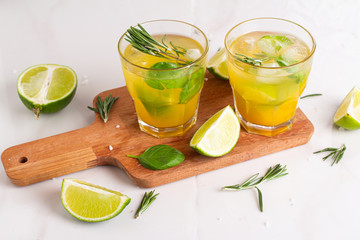 drink with lime ice and rosemary in a glass