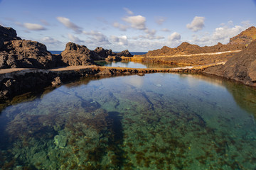 Naklejka premium Garachico volcanic natural pools, volcanic rocks in Atlantic ocean, long exposure, Tenerife, Canary islands, Spain