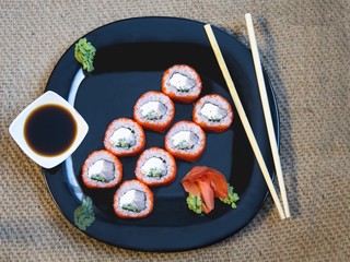 Fototapeta na wymiar Sushi rolls closeup on burlap background