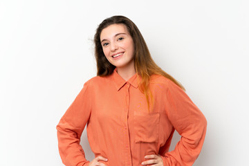 Young brunette girl over isolated white background posing with arms at hip and smiling