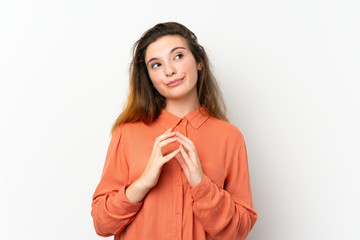 Young brunette girl over isolated white background scheming something
