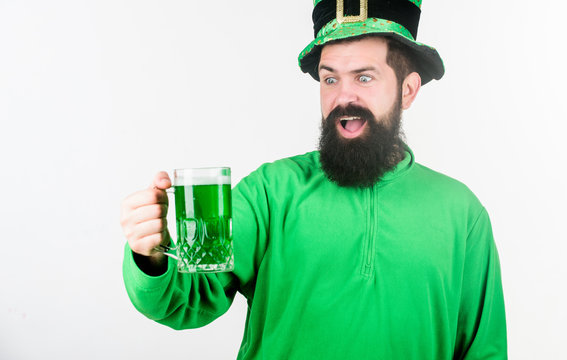 Raising the green and stepping out. Irish man with beard drinking green beer. Hipster in leprechaun hat holding beer mug. Bearded man toasting to saint patricks day. Celebrating saint patricks day