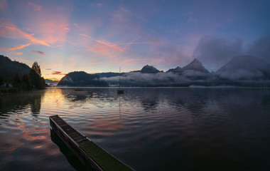 Peaceful autumn Alps mountain lake. Sunrise Wolfgangsee lake view, St. Wolfgang im Salzkammergut, Upper Austria.