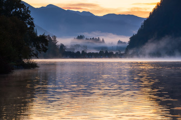 Peaceful autumn Alps mountain lake. Sunrise Wolfgangsee lake view, St. Wolfgang im Salzkammergut, Upper Austria.