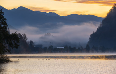 Peaceful autumn Alps mountain lake. Sunrise Wolfgangsee lake view, St. Wolfgang im Salzkammergut, Upper Austria.