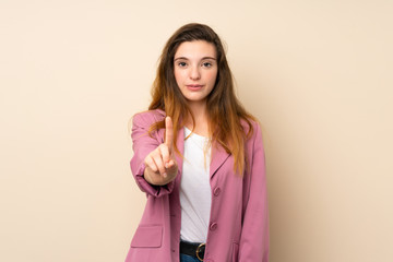 Young brunette girl with blazer over isolated background showing and lifting a finger