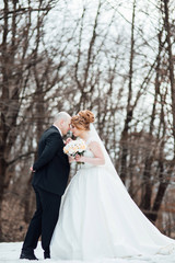 Soulful photo of the newlyweds hugging and kissing each other in the wedding day. Amazing bride and groom. Sensual romantic moment. Wedding. Stylish and beautiful.