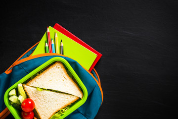 Back to school concept. Lunch box, stationery and backpack.