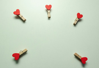 White background. A small wooden clothespin with a red heart. Love. Valentine's day. Happy.